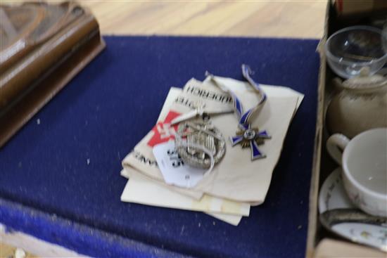 A German Red Cross armband and paperwork, a mothers cross, a general assault badge